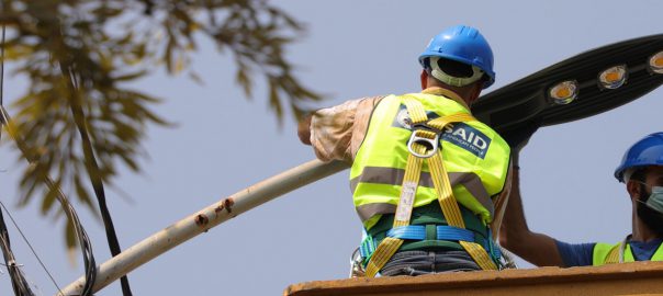 USAID Workers Fixing Street Light