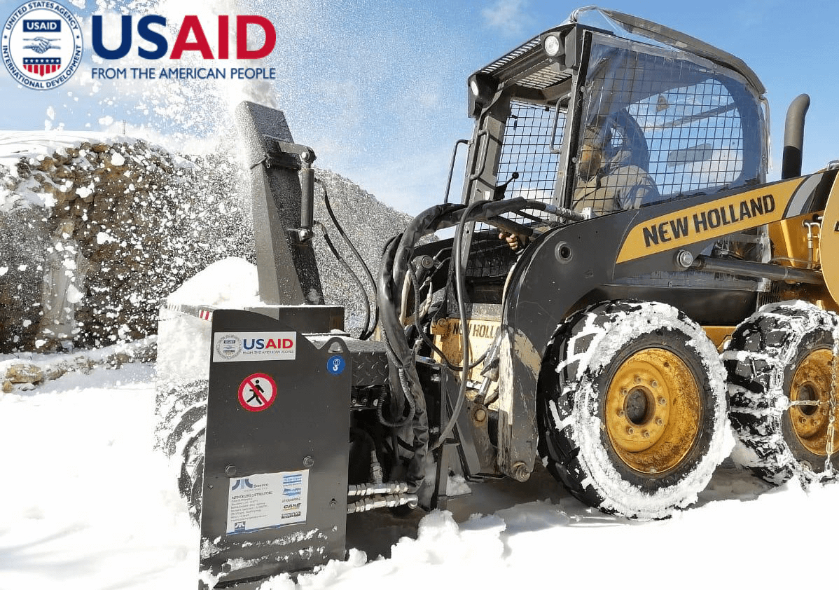 USAID Tractor removing snow